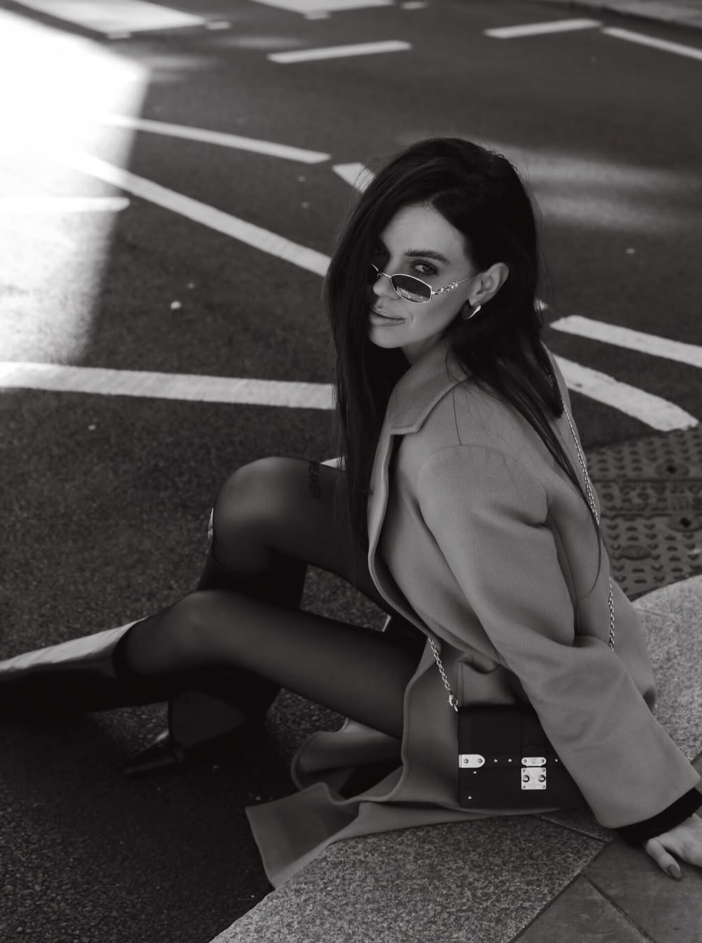 Editorial portrait in cream coat on a London street at golden hour